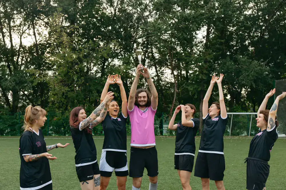 Bravo team celebrating their finals victory with raised arms
