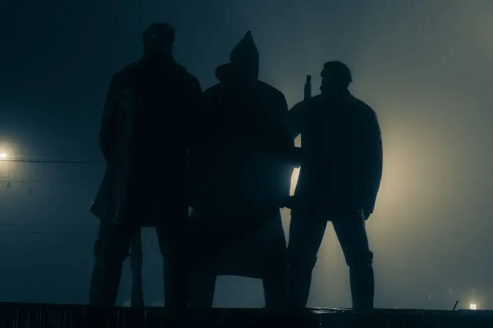 Charlie squad standing triumphantly in front of their drop zone map